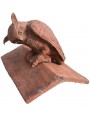 Owl on the top of an ancient saddle roof tile