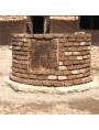 Work in progress of the SATOR assembly inserted in a circular well of ancient bricks