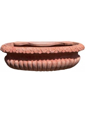 Large terracotta sink basin with ornate pods