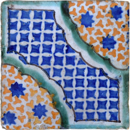 Antica piastrella di maiolica con stelle azzurre