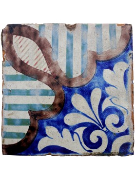 Majolica tile with stripes, blue and white flowers framed by manganese border