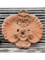 antique wall frieze with mask and shell