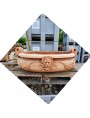 Bellissima vasca ovale in terracotta con festoni e satiri