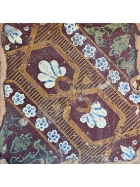 Brown majolica old tile with small palms