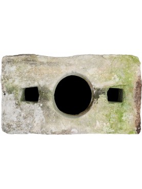 ancient rectangular well in white limestone with three holes